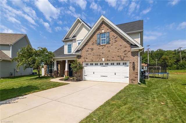 view of front of house featuring a garage, a trampoline, and a front yard