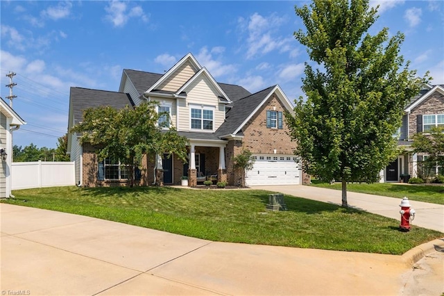 craftsman-style house featuring a front yard and a garage