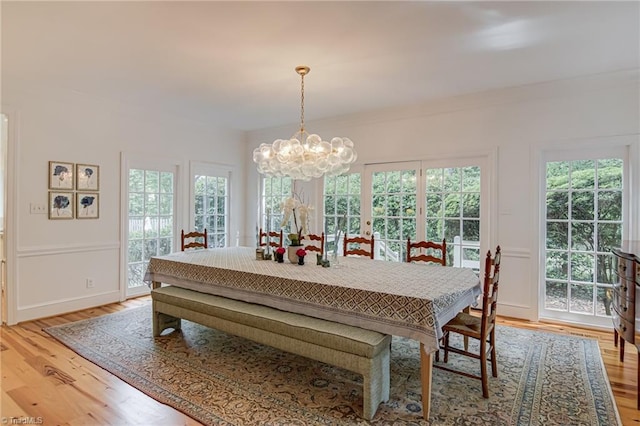 dining space featuring a chandelier and light wood finished floors