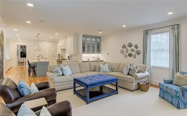 living area featuring recessed lighting, baseboards, and light wood-style floors