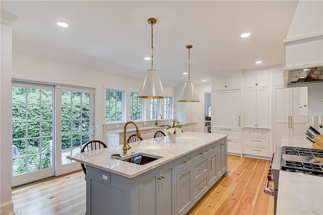 kitchen with a sink, plenty of natural light, and gray cabinets