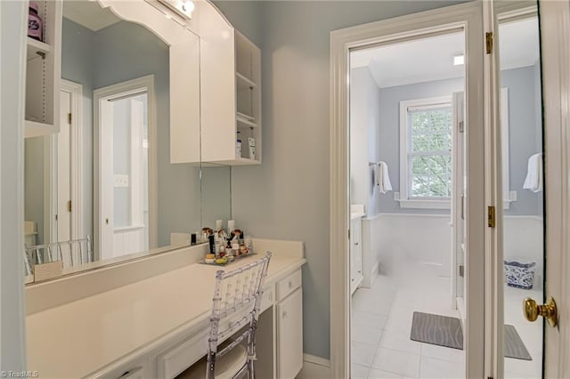 bathroom with vanity, baseboards, and ornamental molding