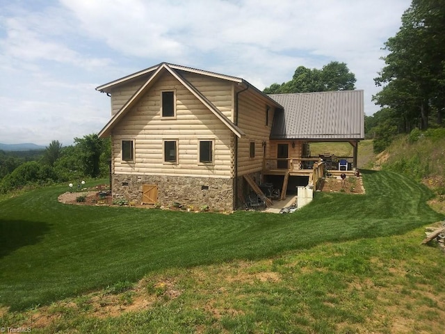 back of house featuring a wooden deck and a yard