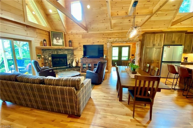 1295 Will Vannoy Rd, West Jefferson, NC 28694 - living area with wood walls, light wood finished floors, high vaulted ceiling, a wooden ceiling with exposed beams, and a fireplace
