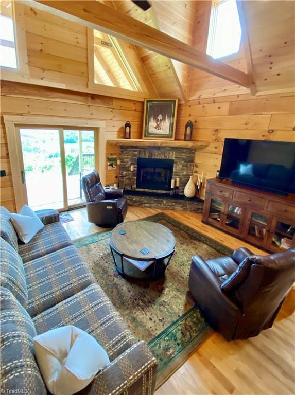 1295 Will Vannoy Rd, West Jefferson, NC 28694 - living area with wood finished floors, wood walls, a stone fireplace, a wood ceiling with exposed beams, and high vaulted ceiling