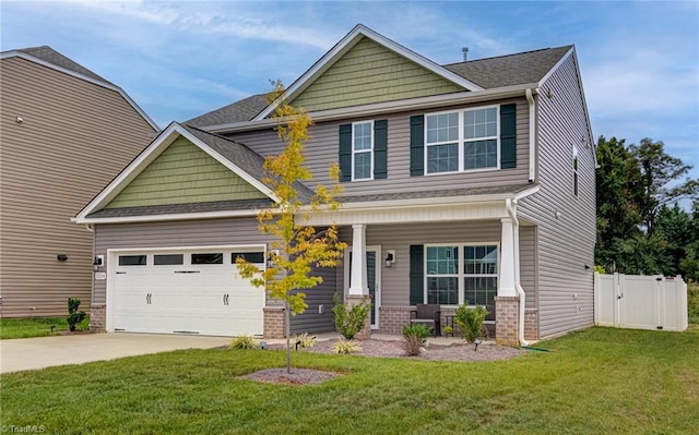 craftsman inspired home with a garage, a front lawn, and covered porch