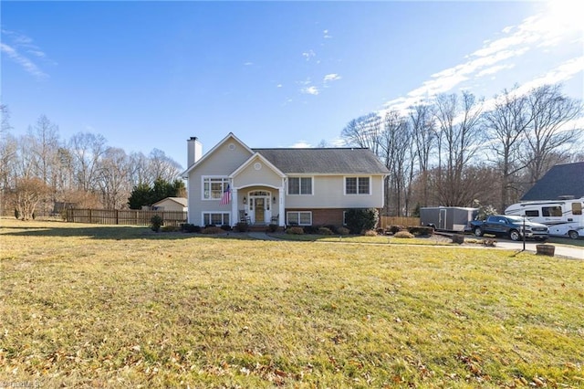 split foyer home with a front lawn