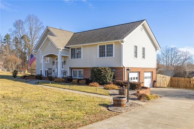 bi-level home featuring a garage and a front yard