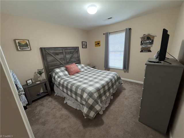 bedroom featuring dark colored carpet, visible vents, and baseboards