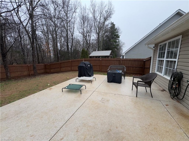 view of patio with area for grilling and a fenced backyard