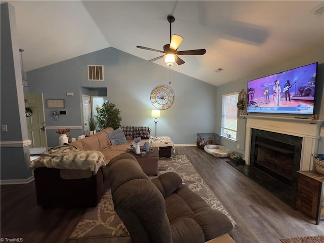 living room featuring wood finished floors, a ceiling fan, visible vents, vaulted ceiling, and a high end fireplace