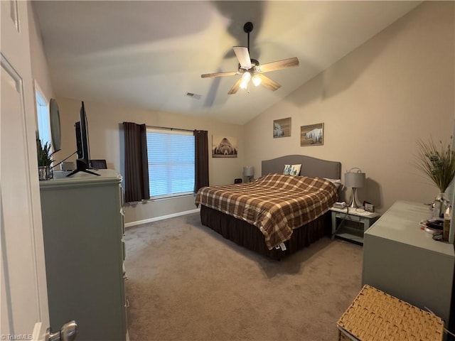 bedroom featuring lofted ceiling, light colored carpet, visible vents, a ceiling fan, and baseboards