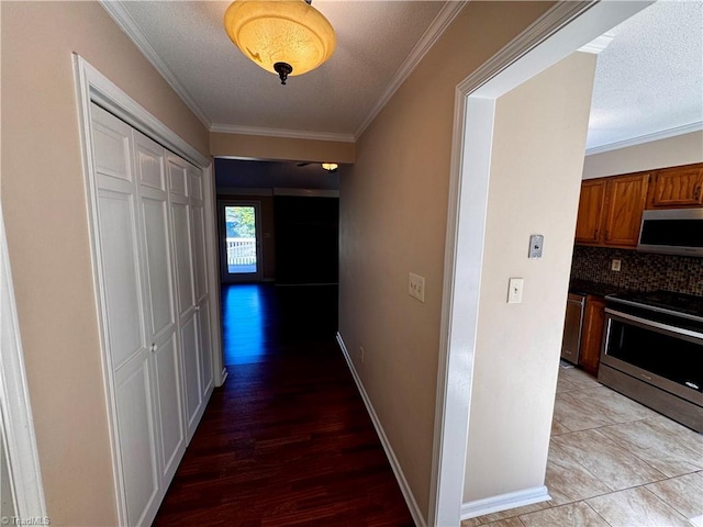 hall featuring ornamental molding, a textured ceiling, and hardwood / wood-style floors