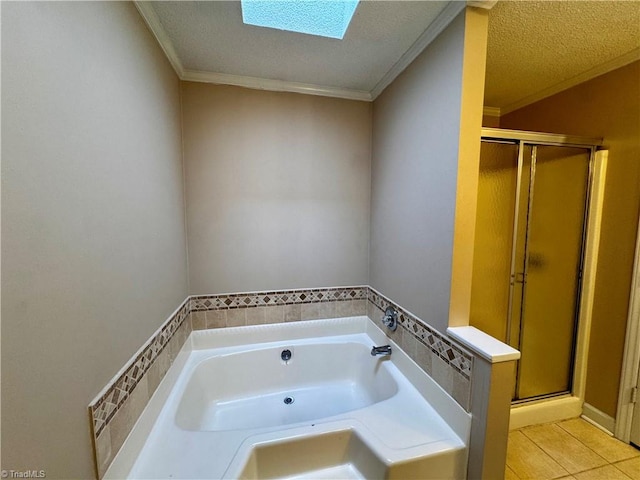 bathroom featuring a skylight, crown molding, separate shower and tub, and a textured ceiling