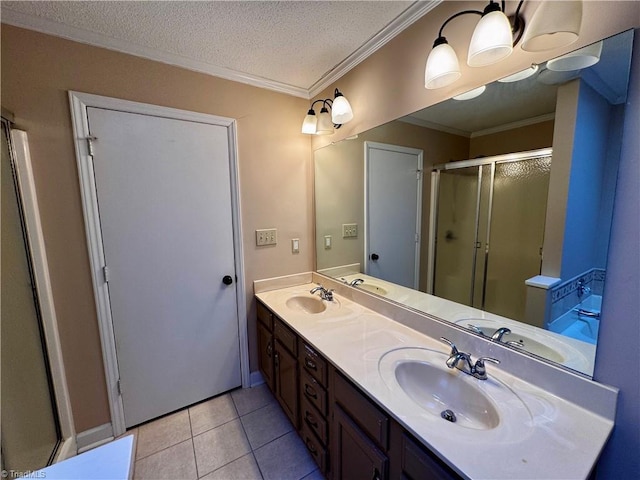 bathroom featuring tile patterned flooring, ornamental molding, a shower with door, vanity, and a textured ceiling