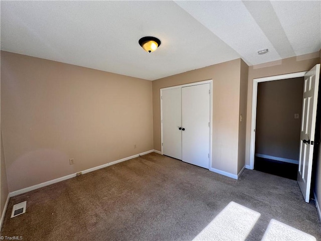 unfurnished bedroom with light carpet and a closet