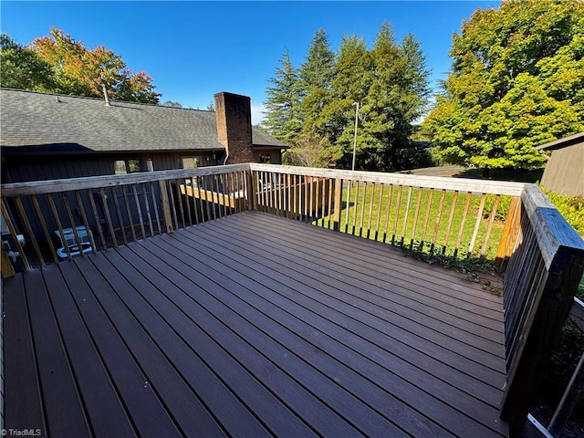 wooden terrace with a lawn