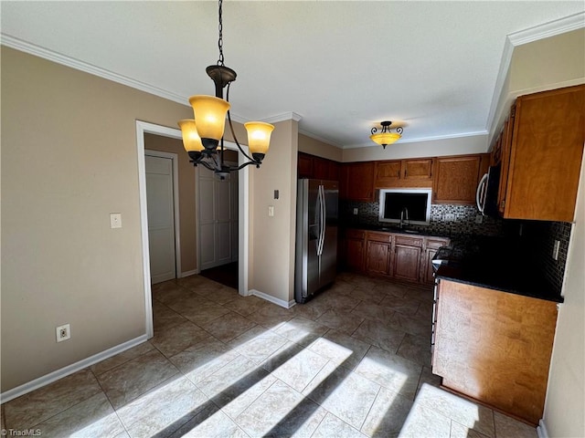 kitchen with appliances with stainless steel finishes, crown molding, decorative light fixtures, and tasteful backsplash