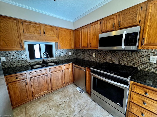 kitchen featuring ornamental molding, appliances with stainless steel finishes, sink, and tasteful backsplash