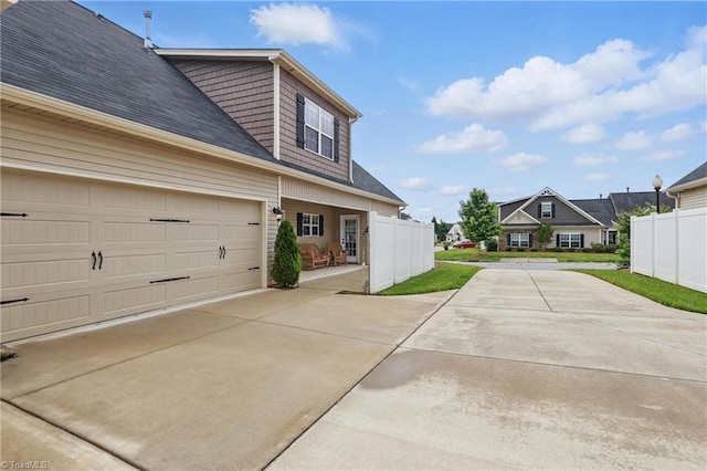 233 Hawks Nest Cir, Clemmons, NC 27012 - view of property exterior featuring driveway, fence, and a garage