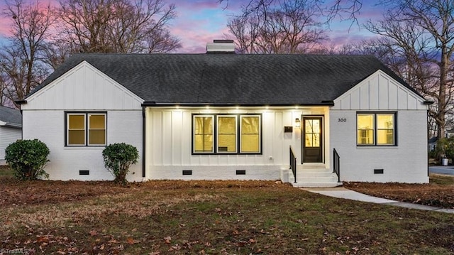 modern inspired farmhouse featuring a lawn