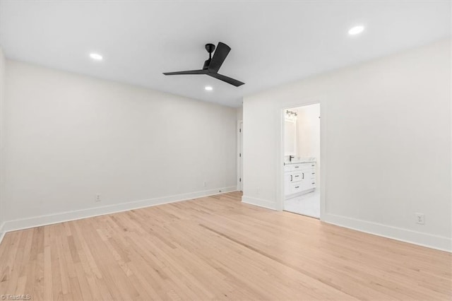 unfurnished bedroom with ensuite bathroom, ceiling fan, and light wood-type flooring