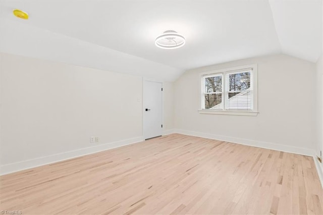 bonus room with lofted ceiling and light hardwood / wood-style floors