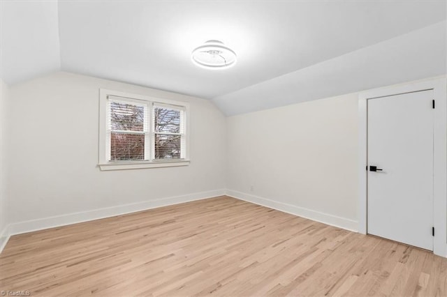 bonus room featuring lofted ceiling and light hardwood / wood-style floors