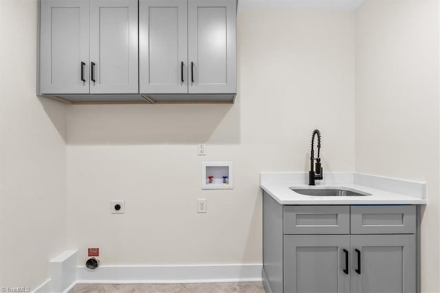 clothes washing area featuring sink, electric dryer hookup, hookup for a washing machine, and cabinets