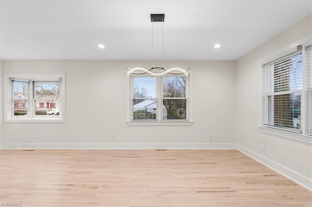 unfurnished dining area with light wood-type flooring