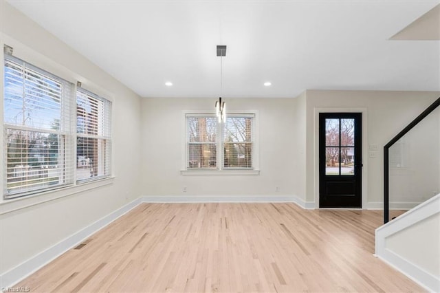 entryway with light hardwood / wood-style flooring and plenty of natural light