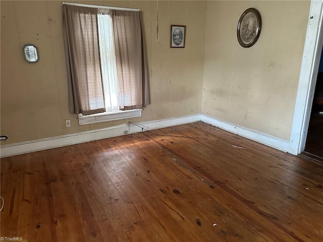 empty room with hardwood / wood-style flooring