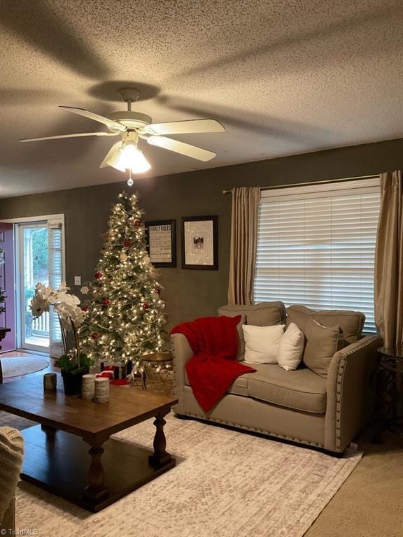 living room featuring a textured ceiling and ceiling fan