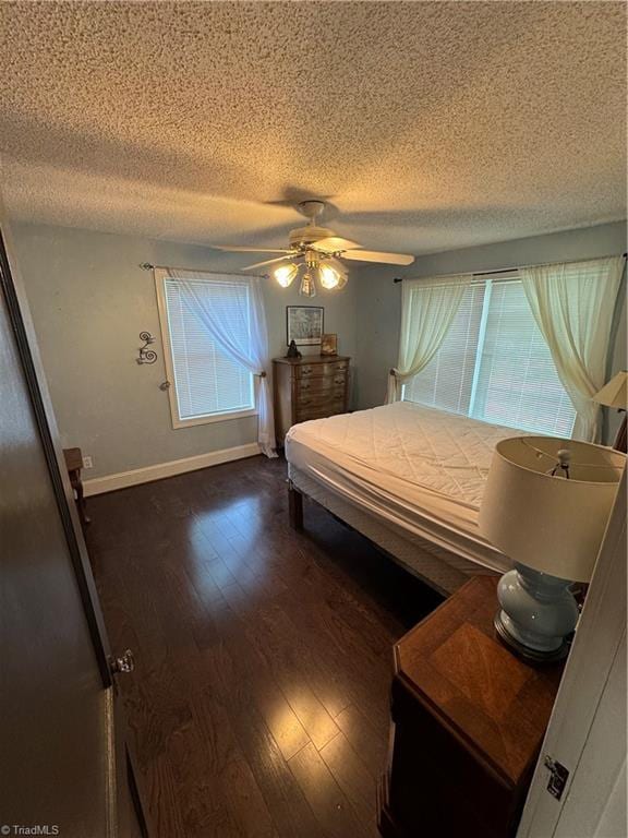 209 Abernathy St NW, Lenoir, NC 28645 - bedroom with a textured ceiling, dark wood-style floors, a ceiling fan, and baseboards