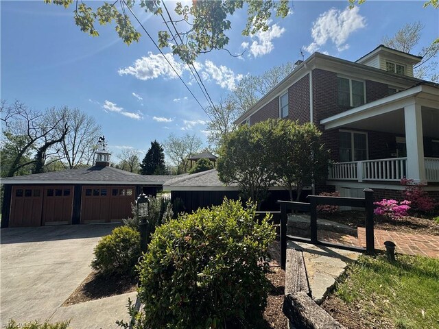 209 Abernathy St NW, Lenoir, NC 28645 - view of home's exterior featuring a garage, a porch, driveway, a gate, and brick siding