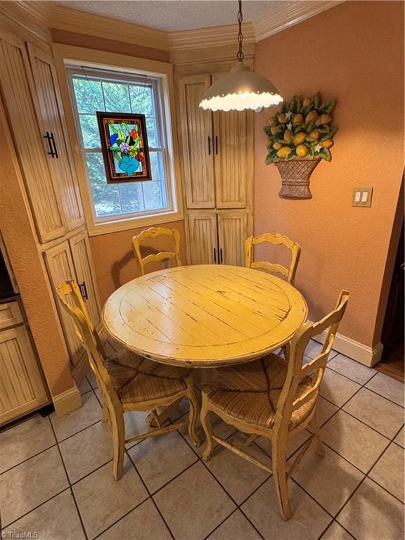 209 Abernathy St NW, Lenoir, NC 28645 - dining space featuring light tile patterned floors, crown molding, baseboards, a textured wall, and a textured ceiling