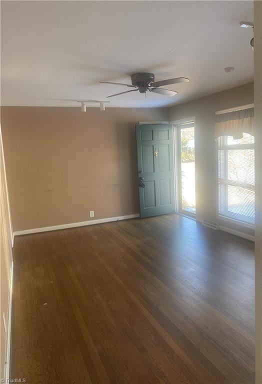 entryway with ceiling fan, dark hardwood / wood-style flooring, and track lighting