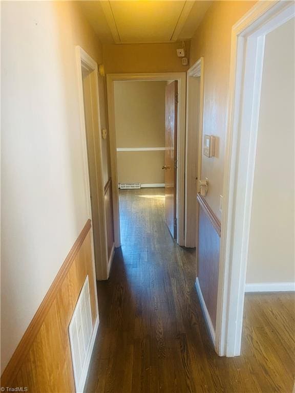 hallway with dark wood-type flooring