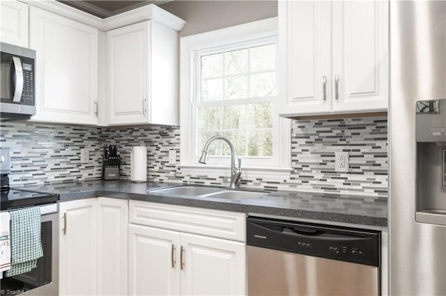 kitchen with white cabinets and appliances with stainless steel finishes