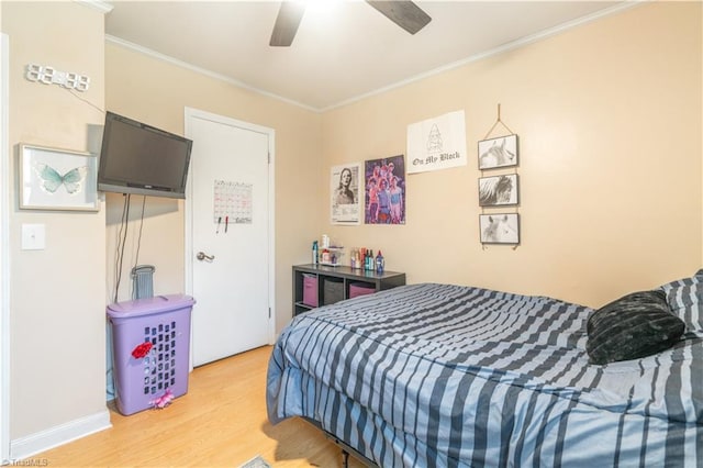 bedroom featuring ceiling fan, ornamental molding, and hardwood / wood-style floors