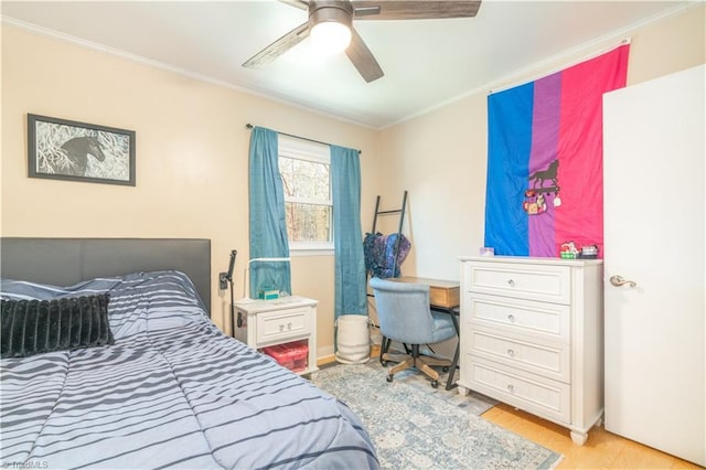 bedroom featuring crown molding, light hardwood / wood-style flooring, and ceiling fan