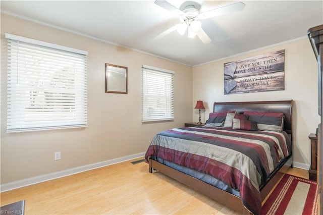 bedroom with ornamental molding and light wood-type flooring