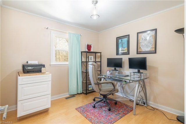 office space featuring crown molding and light hardwood / wood-style flooring