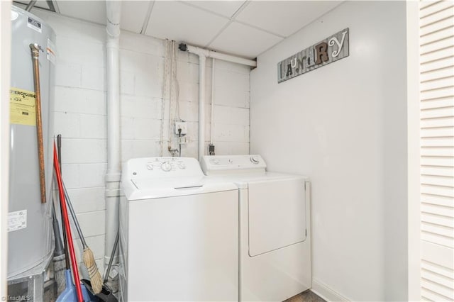 laundry room with separate washer and dryer and water heater