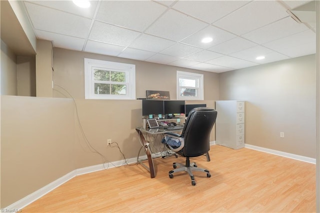 office featuring wood-type flooring and a paneled ceiling