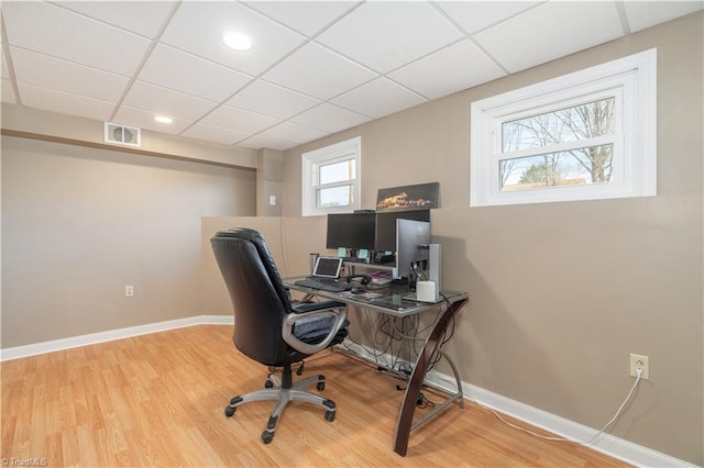 office area featuring wood-type flooring and a paneled ceiling