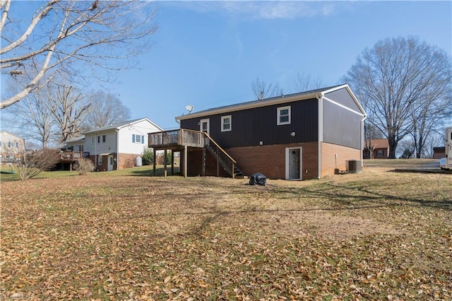 back of property with a yard, central AC, and a deck