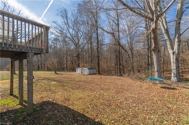 view of yard with a wooden deck and a shed