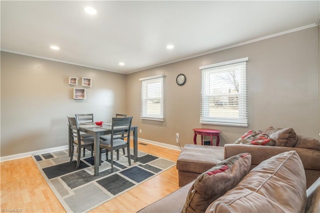 dining area with hardwood / wood-style floors and crown molding