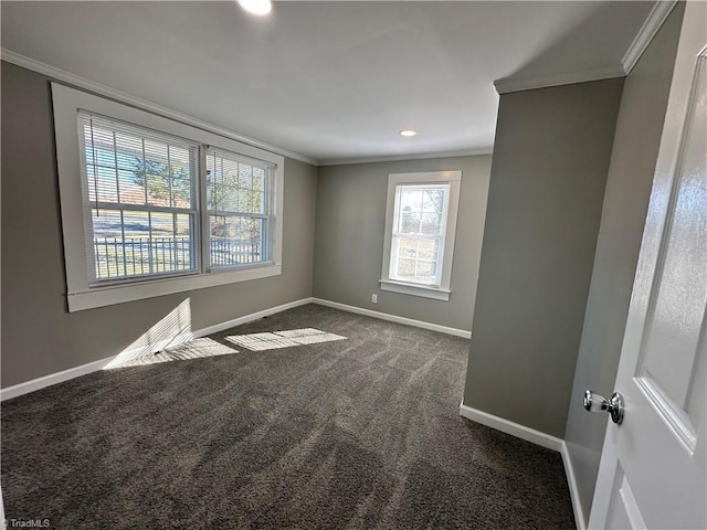 carpeted empty room featuring crown molding